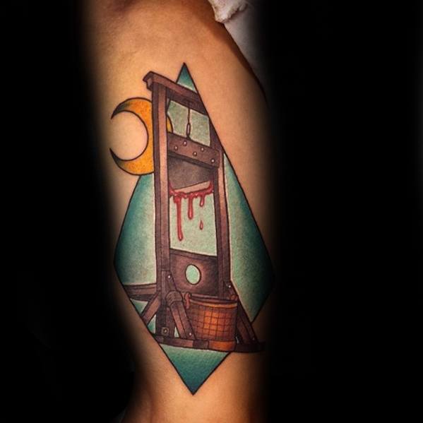 Colorful guillotine tattoo with dripping blood, crescent moon, basket detail, and a teal geometric background for a bold, surreal style.