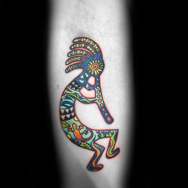 Vibrant Kokopelli tattoo with intricate tribal patterns and bright colors like green, blue, and orange, showcasing dynamic detail and lively energy.