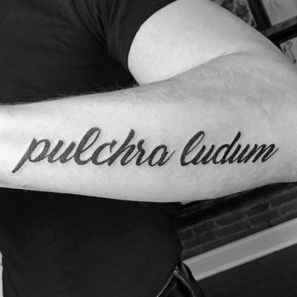 Male Tattoo With Latin Design Outer Forearm