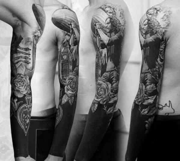 Detailed black and gray full sleeve tattoo of Robert Plant singing, a Zeppelin airship, roses, and London’s Big Ben in the background.
