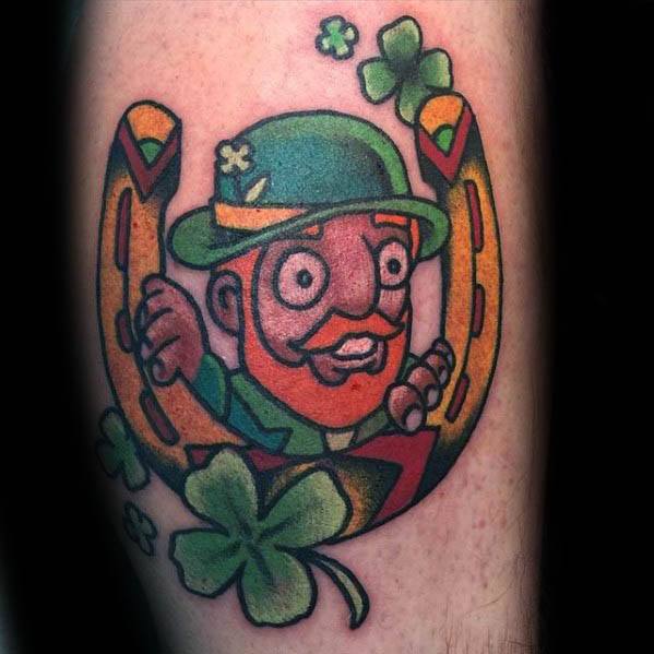 Bright and playful leprechaun tattoo with wide eyes, peeking through a golden horseshoe, surrounded by shamrocks and bold outlines.