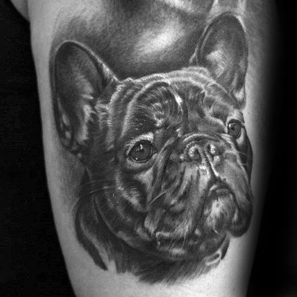 Black and white tattoo of a French Bulldog's face on someone's skin