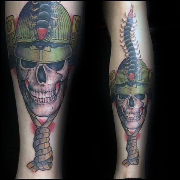 Male Tattoo With Skull Samuari Helmet Centipede Design On Back Of Leg
