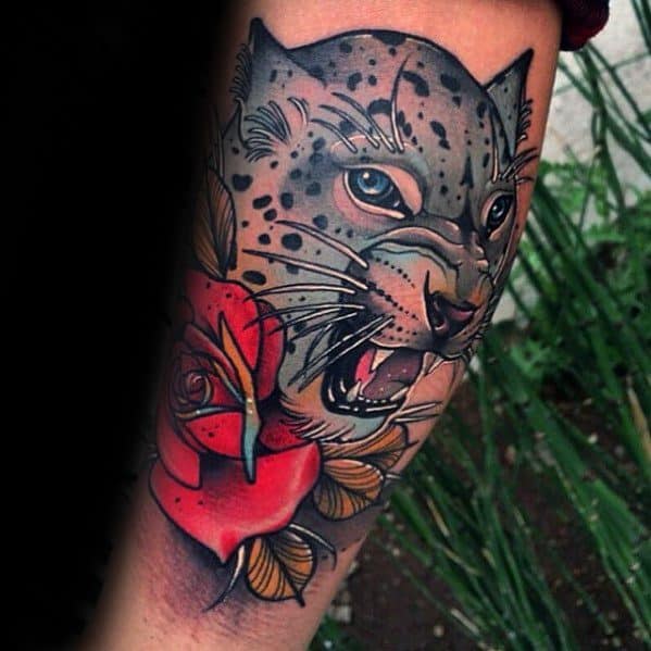 Neo-traditional snow leopard tattoo with fierce eyes, paired with a red rose and golden leaves for a bold and artistic contrast.