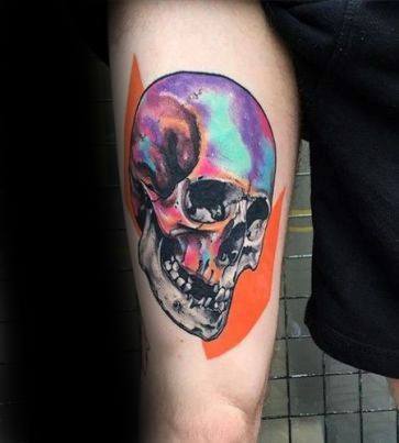 Colorful skull tattoo with iridescent hues over a bright orange geometric background, blending realism and abstract styles.