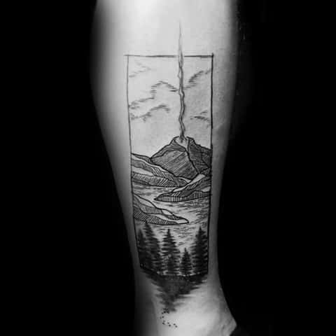 Male Tattoo With Volcano Design On Side Of Leg