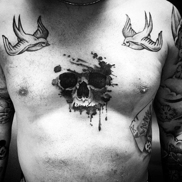 Male Tattoo With Watercolor Skull Design On Upper Chest