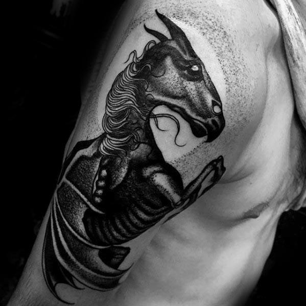 Striking Thestral tattoo on the upper arm, featuring textured dotwork, bold black shading, and flowing mane details.