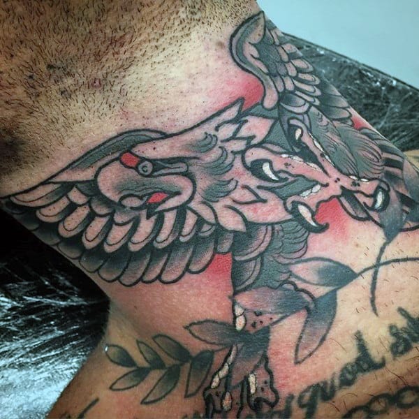 Throat tattoo featuring a bold black and gray winged eagle skull with intricate shading and dynamic details for a fierce look