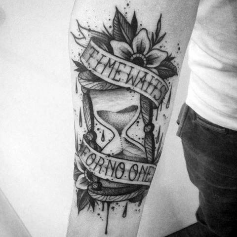 Blackwork tattoo with an hourglass, dripping sand, floral elements, and banners that say Time Waits for No One.