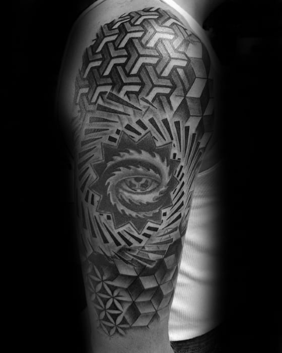 Black and grey Tool-inspired sleeve tattoo featuring a central eye with layered geometric shapes, 3D cubes, and optical illusion patterns.