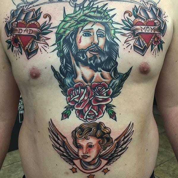 Traditional-style chest tattoo featuring Jesus with a crown of thorns and roses, a winged cherub below, and heart banners labeled “Dad” and “Mom” above.