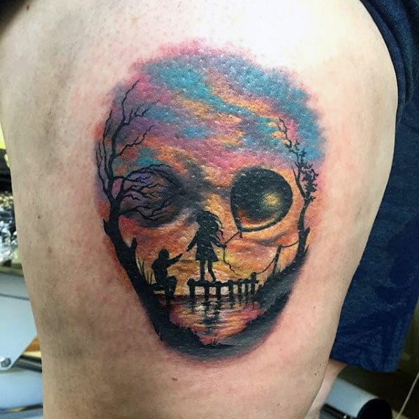 Male Traditional Tattoo Children At Sunset That Looks Like Skull On Thigh