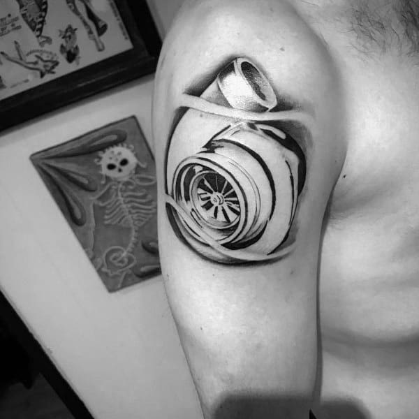 Realistic turbocharger tattoo on the upper arm with bold shading and a torn skin effect, symbolizing speed, power, and a passion for automotive performance.