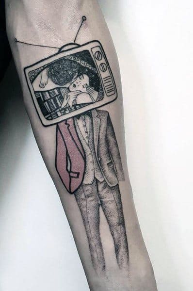 Black and grey tattoo of a headless suited figure with a vintage TV for a head, displaying a romantic kiss on the screen, with subtle red shading.