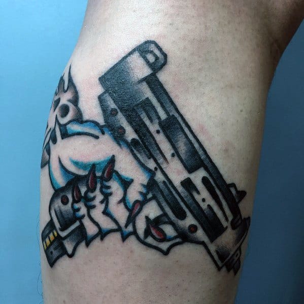 Cartoon-style Uzi tattoo with a clawed hand gripping the gun, featuring bold black outlines, blue shading, and red accents for a dynamic look.