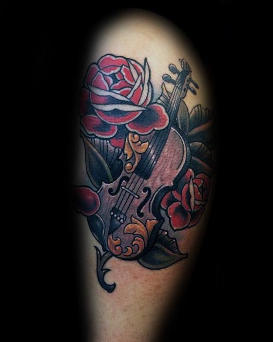 Traditional-style tattoo of a violin adorned with red roses and ornamental patterns, combining musical elegance with classic floral design.