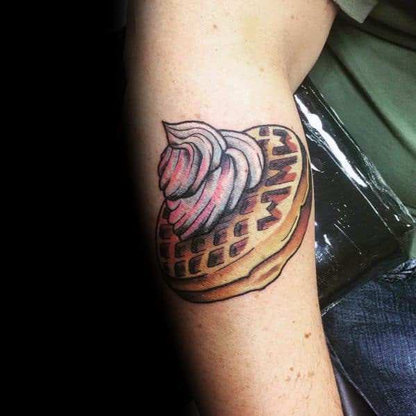 Realistic waffle tattoo with whipped cream and syrup, featuring bold shading and rich textures for a delicious and eye-catching breakfast design.