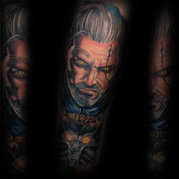 Vibrant Witcher tattoo of Geralt with glowing yellow eyes and detailed scars, paired with a fierce wolf medallion on the forearm.