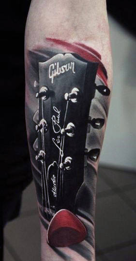 Male With Amazing Guitar Head And Red Block Tattoo
