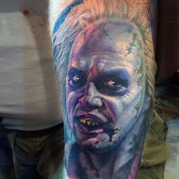Male With Beetlejuice Portrait Arm Tattoo