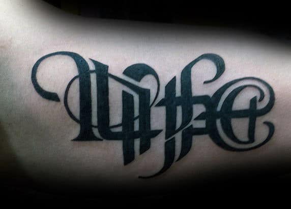 Male With Bicep Tattoo Of Life Death Ambigram Design