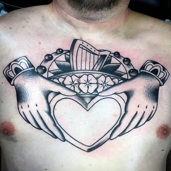 Male With Black Ink Outline Claddagh Chest Tattoo