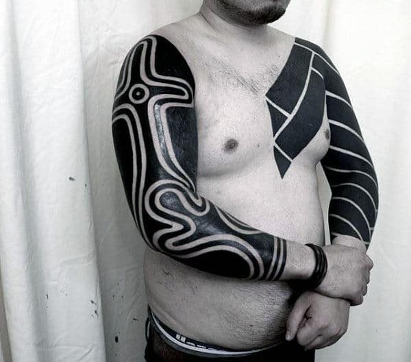 Male With Blackwork Full Arm Tribal Tattoos