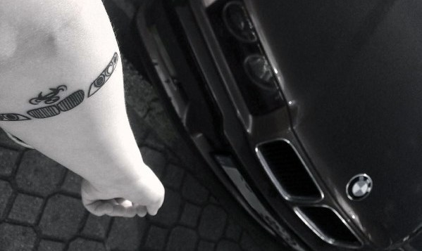 Minimalist BMW grille tattoo on forearm, featuring a sleek black ink design inspired by the iconic front-end look of classic BMWs.