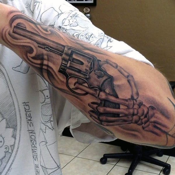 Male With Bones Holding Pistol Tattoo On Forearms