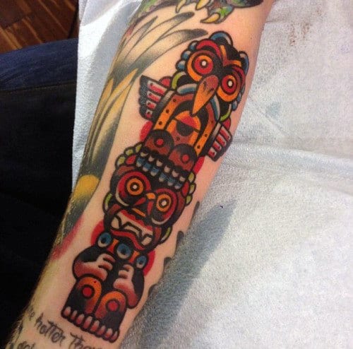 Male With Brightly Colored Neo Traditional Totem Pole Forearm Tattoo