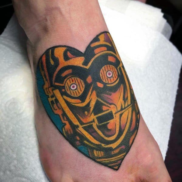 Bold and artistic C-3PO tattoo in a heart shape with vibrant colors and a graphic style, blending sci-fi with a unique, modern design.