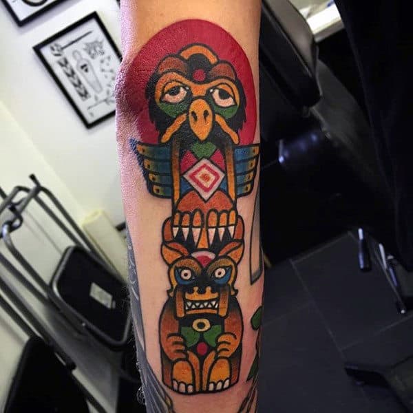 Male With Cartoon Modern Totem Pole Forearm Tattoo
