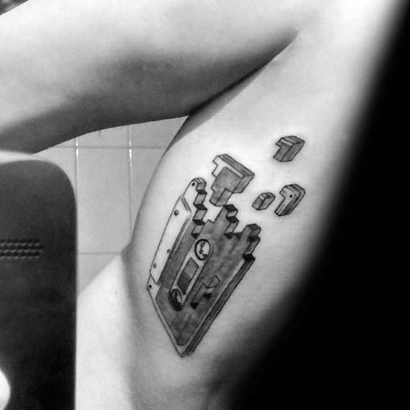 Male With Cassette Tape Broken Pieces Inner Arm Tattoo