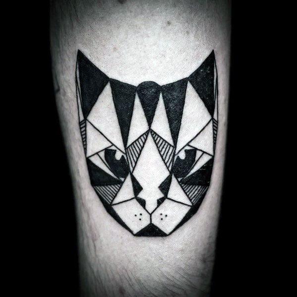 Bold geometric cat face tattoo with sharp black and white patterns, creating a modern and symmetrical design.
