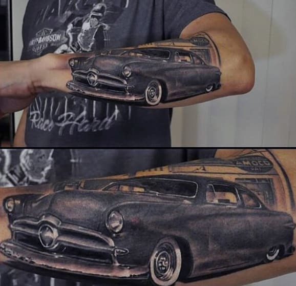 A detailed vintage car tattoo that aligns seamlessly from an arm to a hand