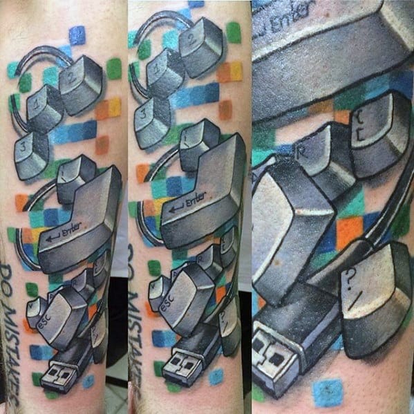 Vibrant tattoo of scattered keyboard keys with a USB plug and colorful pixel blocks, blending tech chaos with digital creativity.