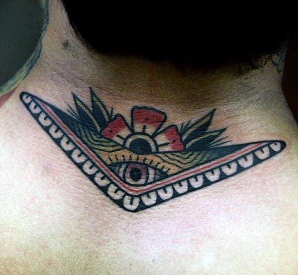 Boomerang tattoo on the upper back with an all-seeing eye, tribal patterns, red flower, and bold border design.