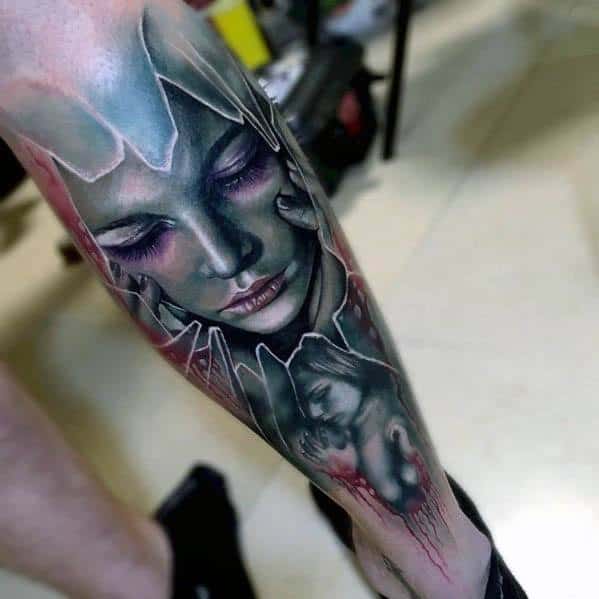 Vibrant tattoo of a woman's serene face behind shattered glass, blending soft purple tones and emotional depth with a surreal broken effect.