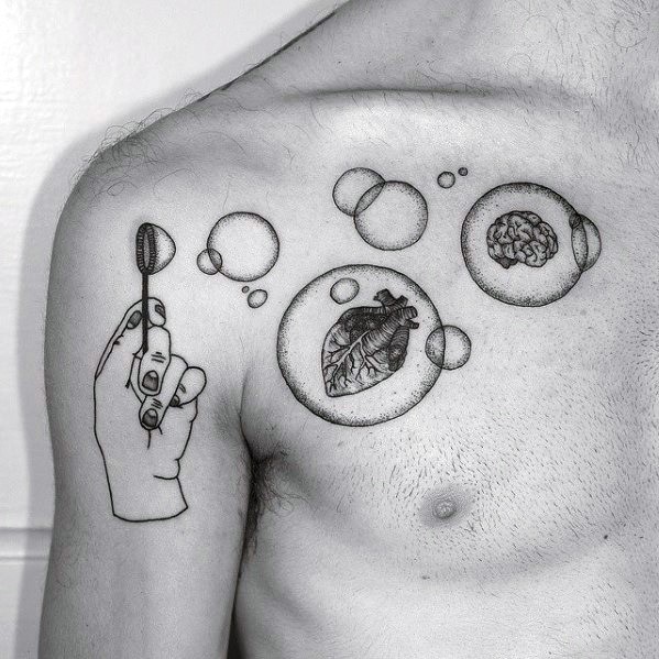 Black and white tattoo of a hand holding a bubble wand, with bubbles containing a heart and brain, creating a symbolic and surreal design.