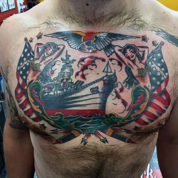 Battleship-themed chest tattoo with mermaids, American flags, and a colorful bald eagle