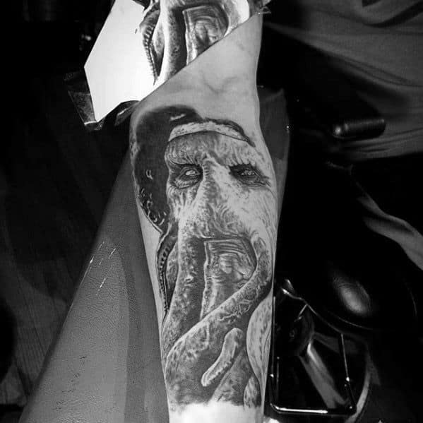 Davy Jones-inspired black and white tattoo of a detailed octopus on a person's leg