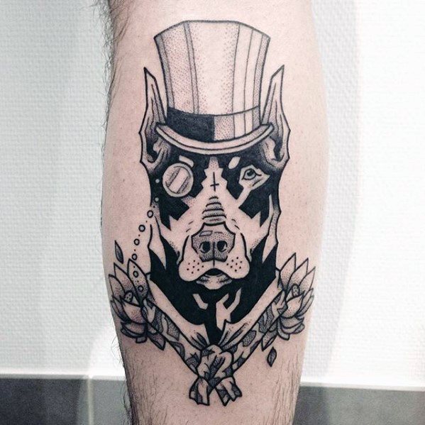 Stylized black linework Doberman tattoo featuring a top hat, monocle, and floral accents for a whimsical and gentlemanly design.