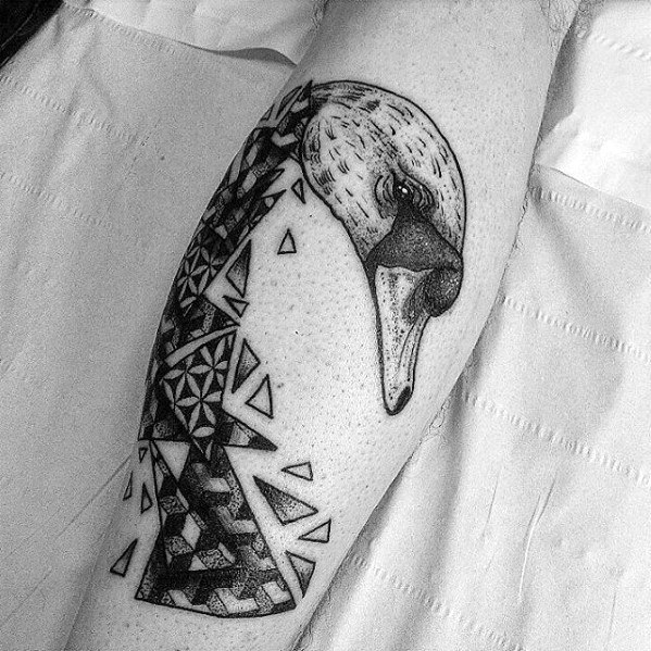 Geometric swan tattoo with a realistic head and fragmented triangular body pattern, combining nature with bold abstract design.