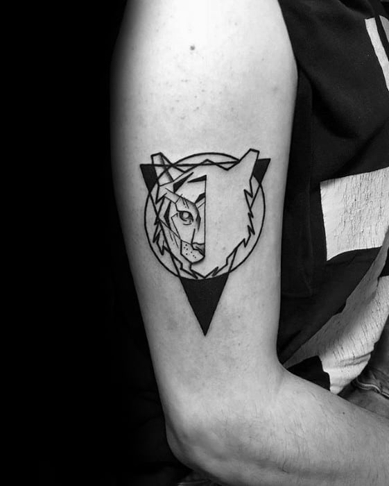 Minimalist geometric tiger tattoo on upper arm, with bold black triangle and circle framing a stylized tiger face for a clean modern look.