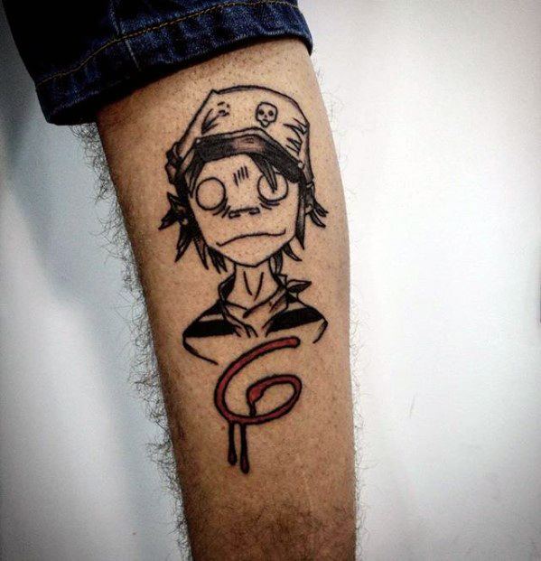 Minimalist tattoo of 2D from Gorillaz with blank eyes, wearing a beanie, and a dripping red “G” logo below his portrait.