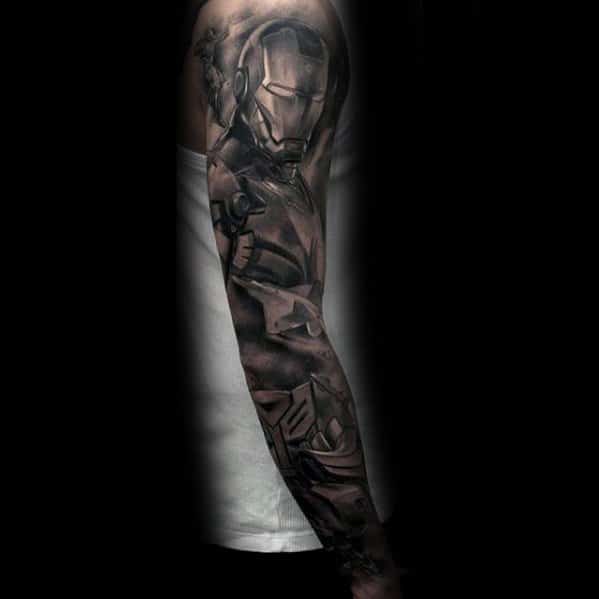 Iron Man tattoo in black and gray, showcasing a highly detailed depiction of his full armor in a dynamic pose, extending down the arm with intricate shading and depth.