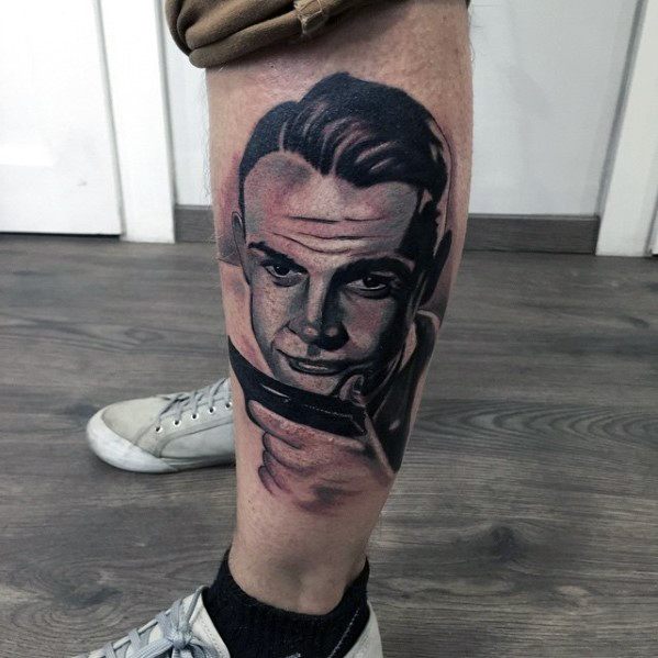 Male With Cool James Bond Tattoo Design On Side Of Leg
