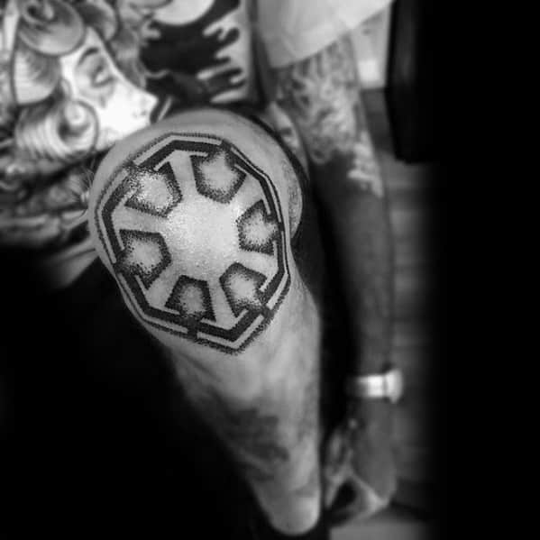 Sith Empire symbol tattooed over the knee in bold black ink with a dotwork shading effect that contours to the shape of the kneecap.