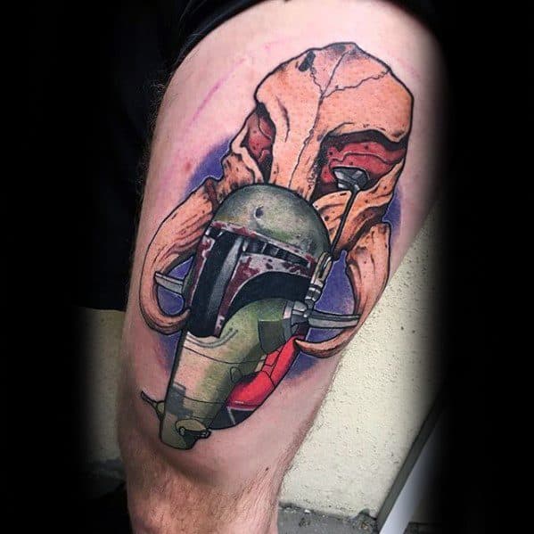 Detailed tattoo of Boba Fett's helmet and Slave I ship over a large Mythosaur skull, blending realism with soft color gradients on the thigh.